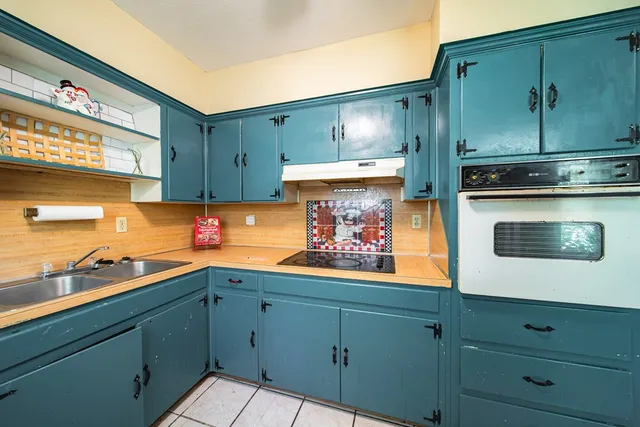 a kitchen with stainless steel appliances white cabinets and a stove