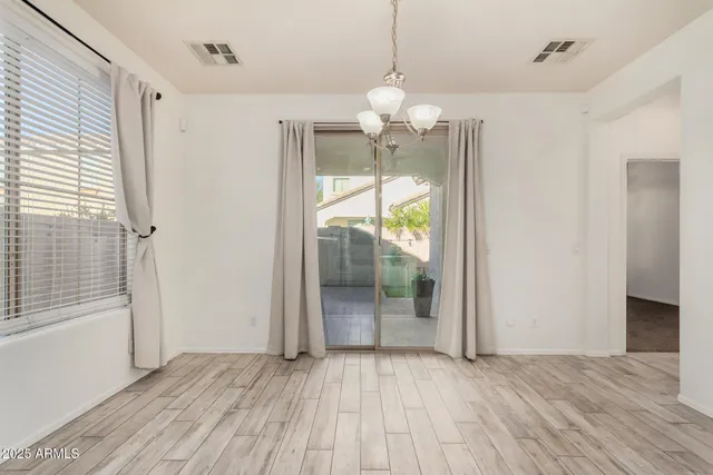 an empty room with closet and a ceiling fan