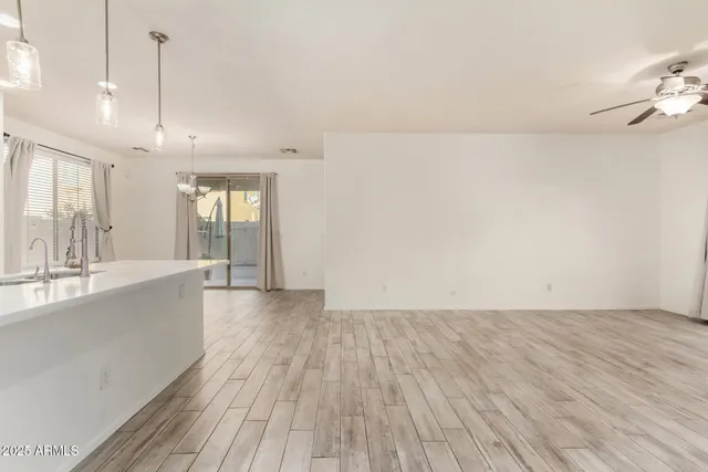 a view of a livingroom with a ceiling fan and window