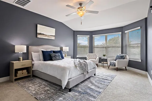 a bedroom with a bed and a couch