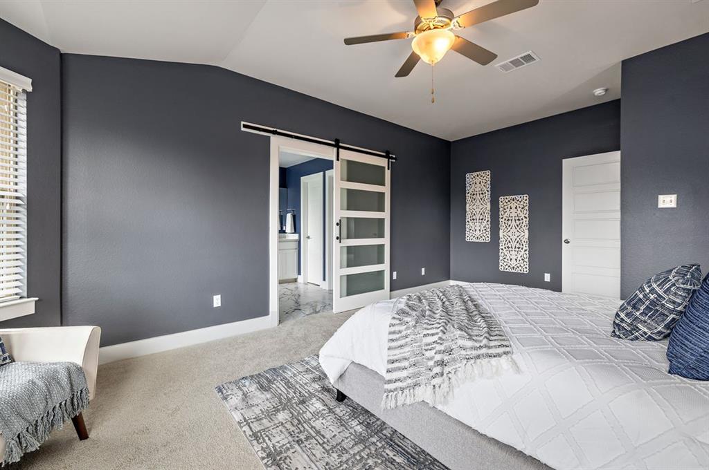 3605 Talladega Trace Austin, TX 78728 - Photo 17 of 27 a spacious bedroom with a large bed and a chandelier