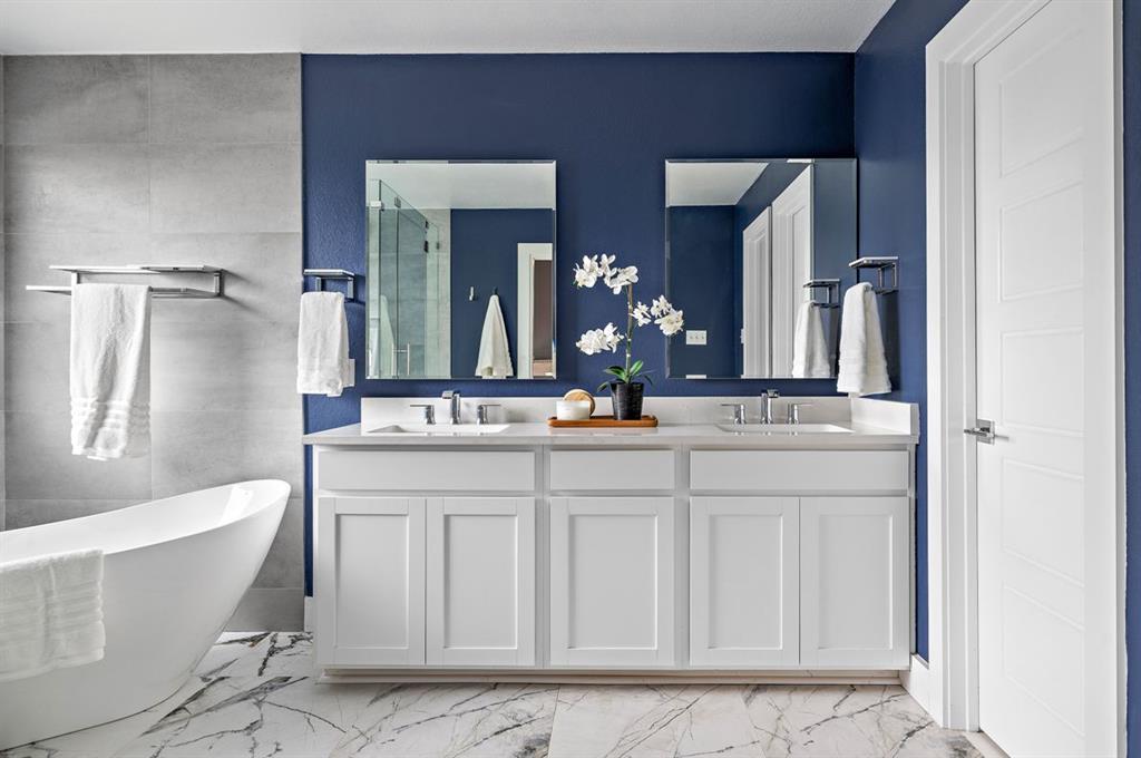 3605 Talladega Trace Austin, TX 78728 - Photo 18 of 27 a bathroom with a double vanity sink a mirror and a bathtub