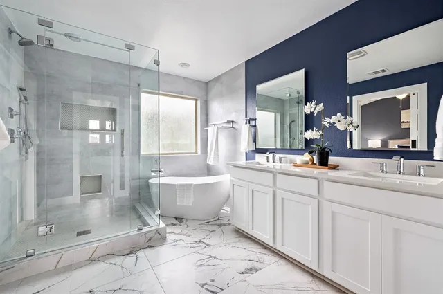 a bathroom with a double vanity sink mirror and shower