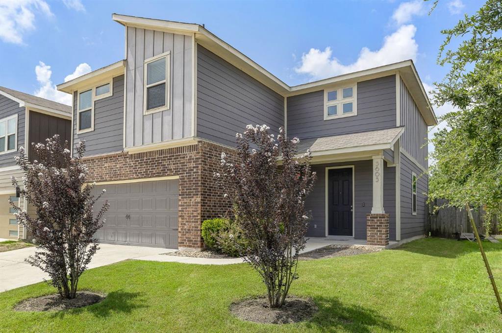 3605 Talladega Trace Austin, TX 78728 - Photo 2 of 27 a front view of a house with a garden and trees