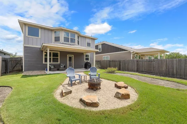 a view of a house with backyard sitting area and garden