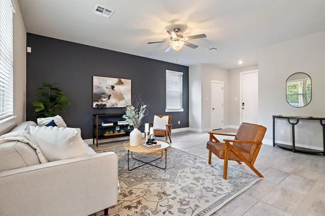 a living room with furniture and a chandelier