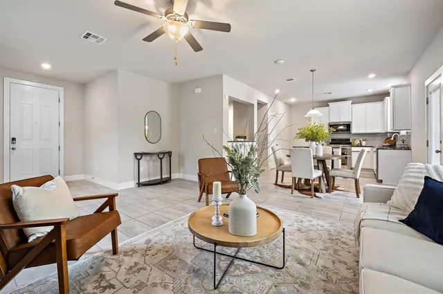 a living room with furniture and kitchen view