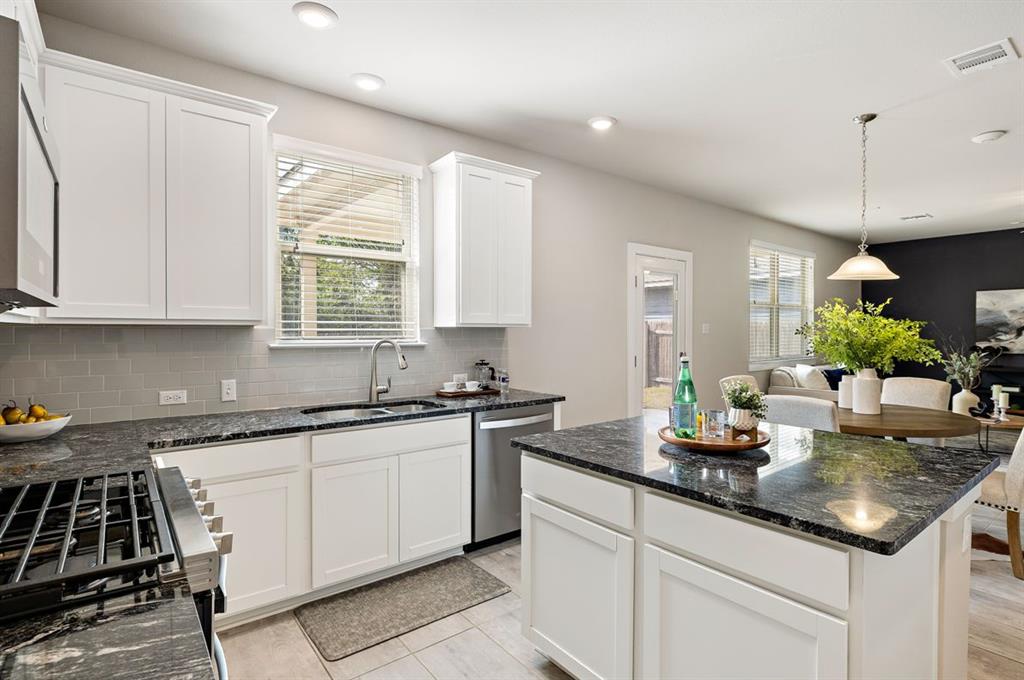3605 Talladega Trace Austin, TX 78728 - Photo 8 of 27 a kitchen with sink stove and cabinets