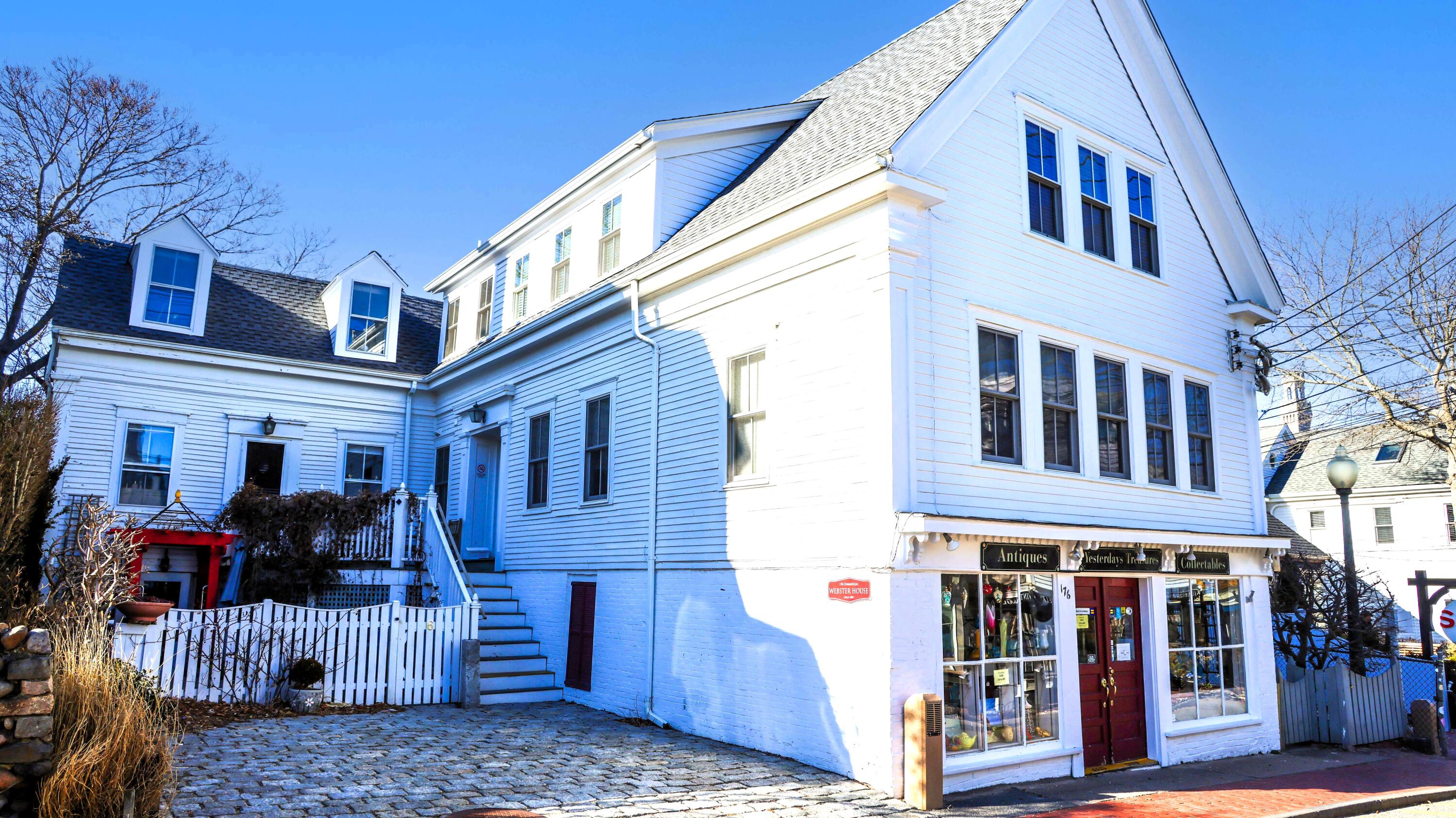 176 Commercial Street, Unit U2 Provincetown, MA 02657 - Photo 1 of 29 a front view of a building with glass windows and umbrellas