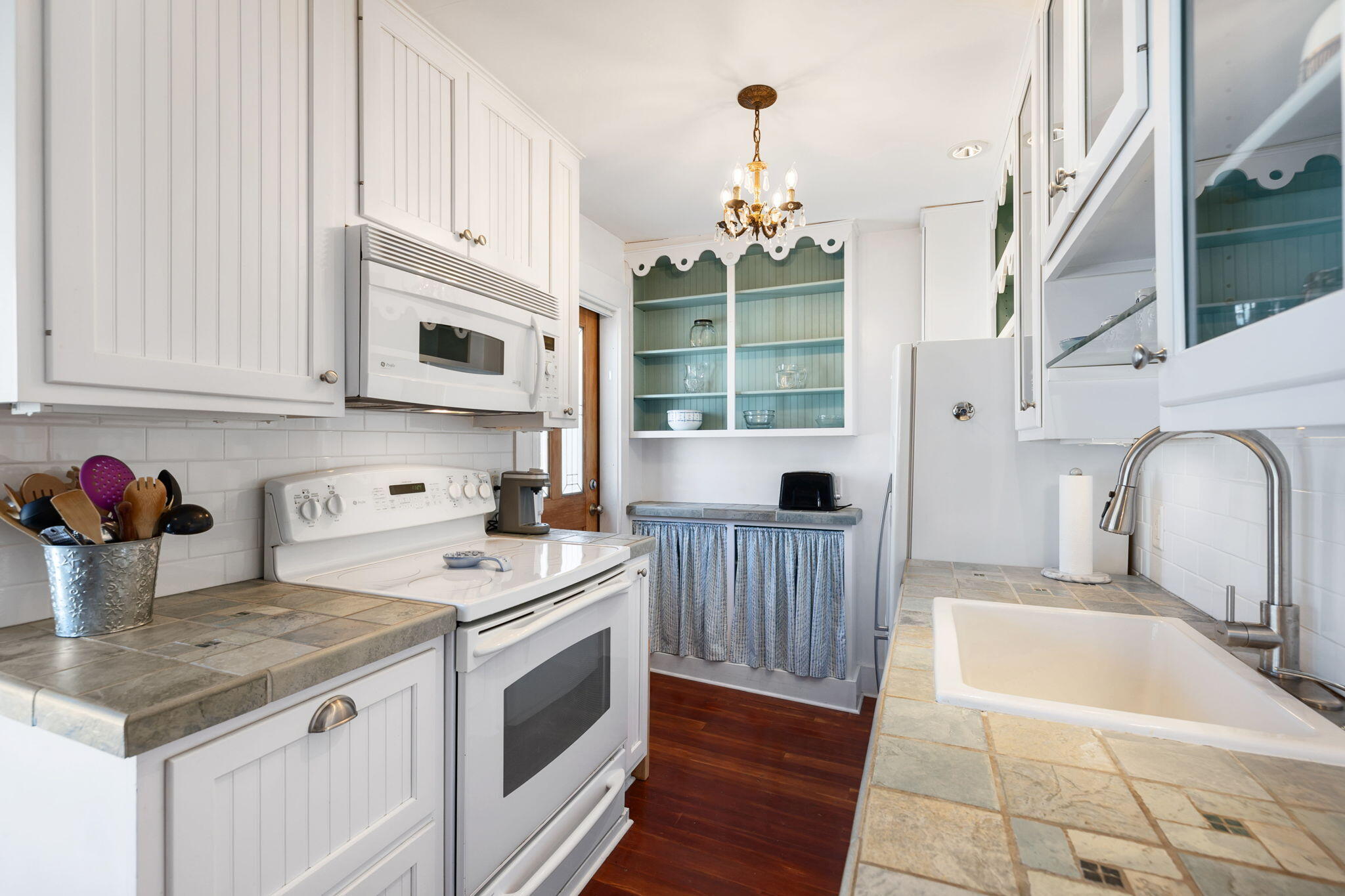 176 Commercial Street, Unit U2 Provincetown, MA 02657 - Photo 12 of 29 a kitchen with stainless steel appliances granite countertop a sink stove and cabinets