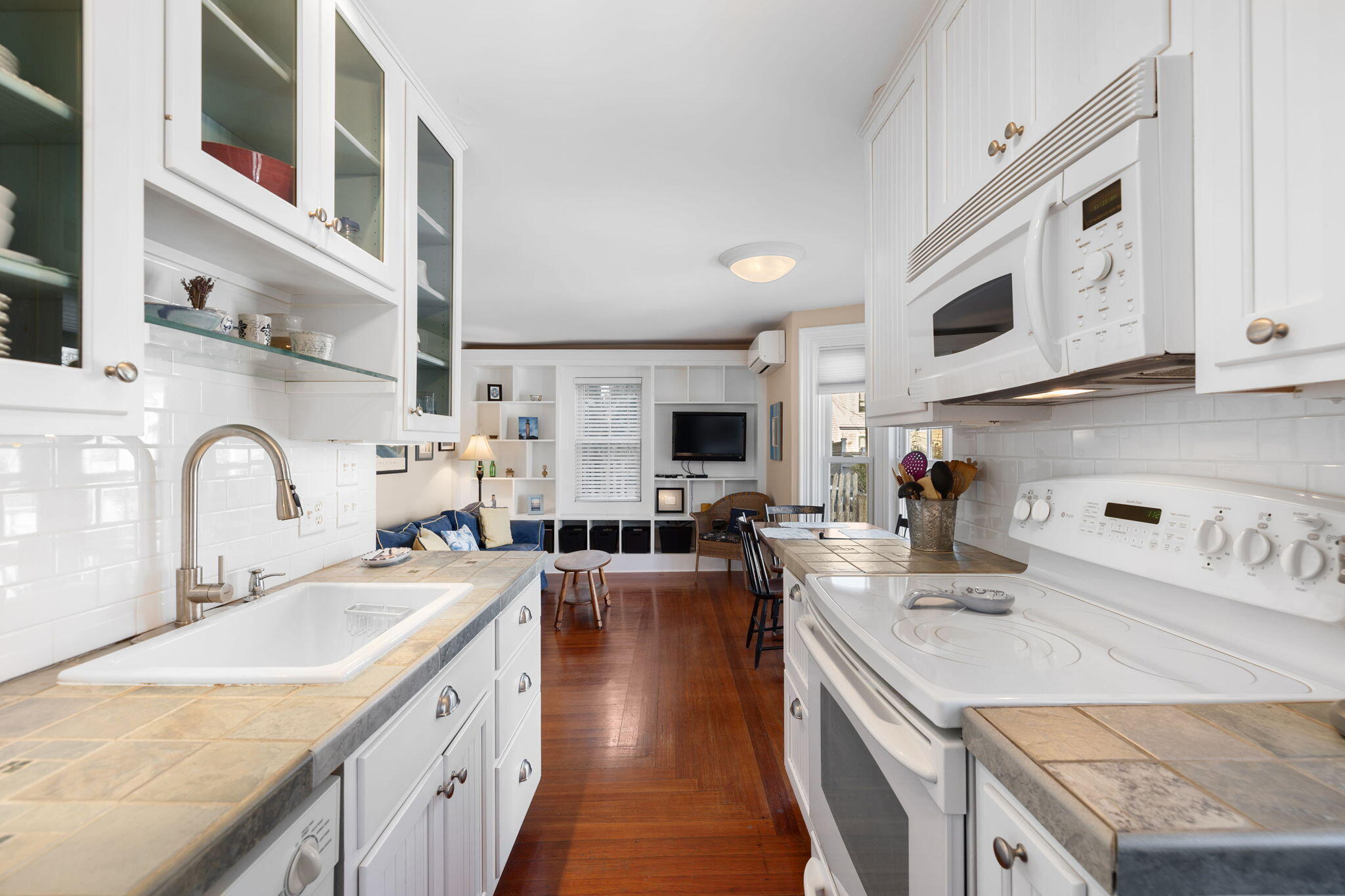 176 Commercial Street, Unit U2 Provincetown, MA 02657 - Photo 13 of 29 a kitchen with stainless steel appliances granite countertop a sink stove and cabinets