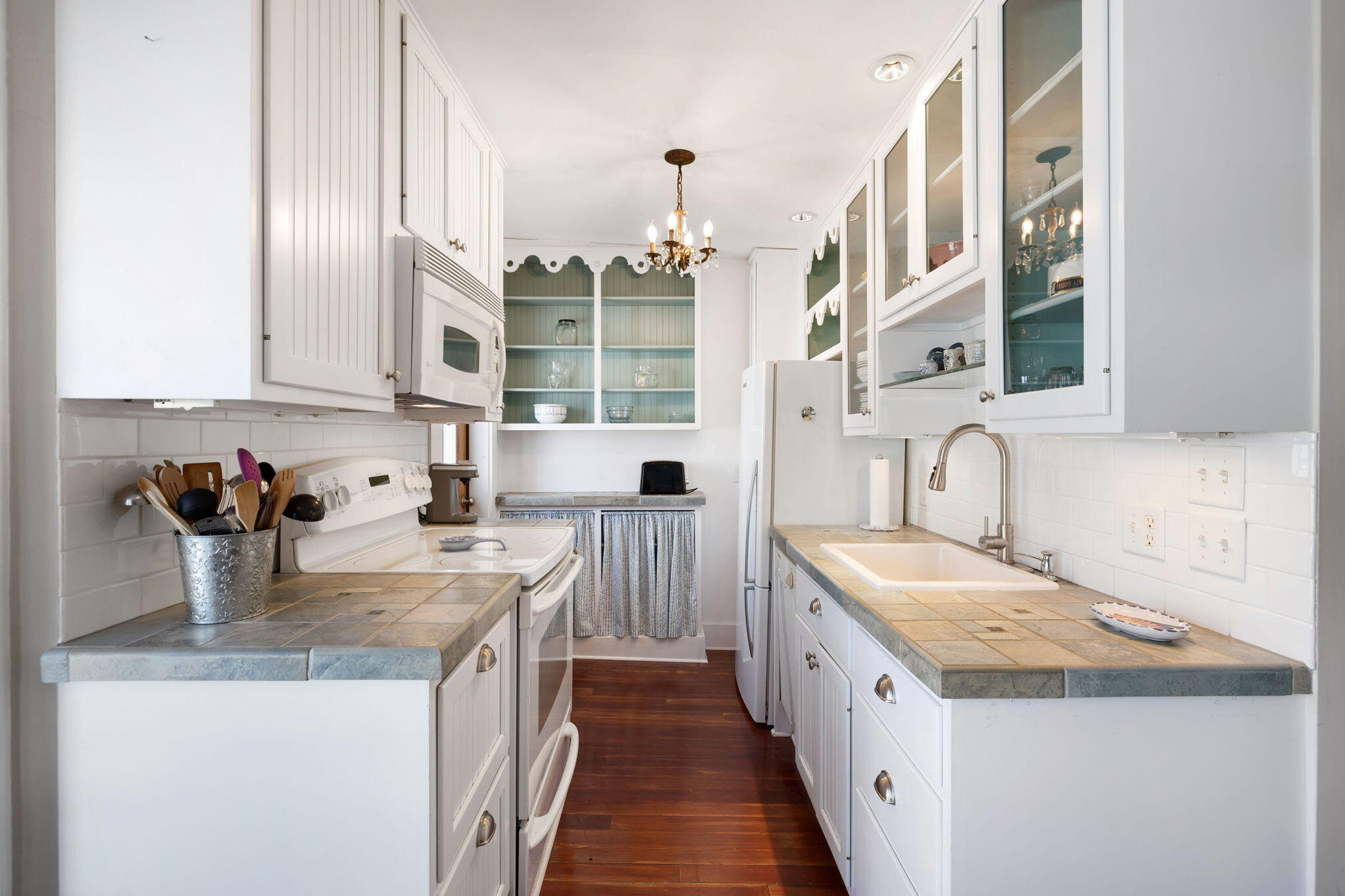 176 Commercial Street, Unit U2 Provincetown, MA 02657 - Photo 16 of 29 a kitchen with sink a stove and cabinets