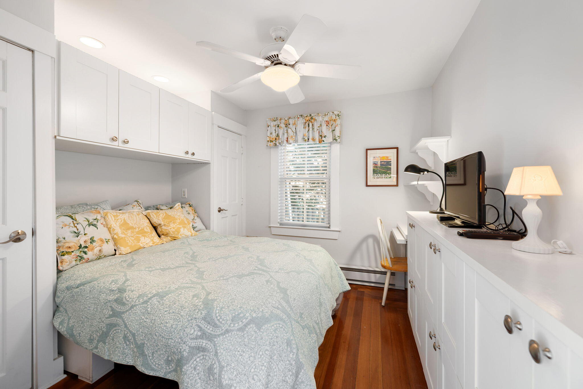 176 Commercial Street, Unit U2 Provincetown, MA 02657 - Photo 19 of 29 a bedroom with a bed and a flat tv screen on the dresser