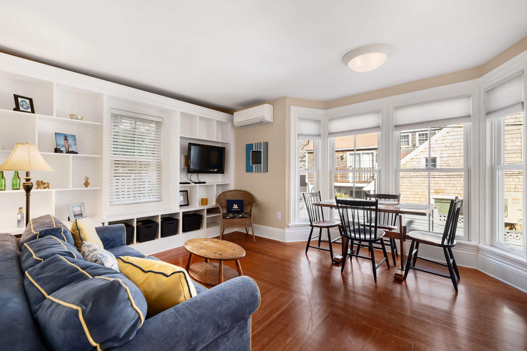 176 Commercial Street, Unit U2 Provincetown, MA 02657 - Photo 8 of 29 a living room with furniture floor to ceiling window and wooden floor
