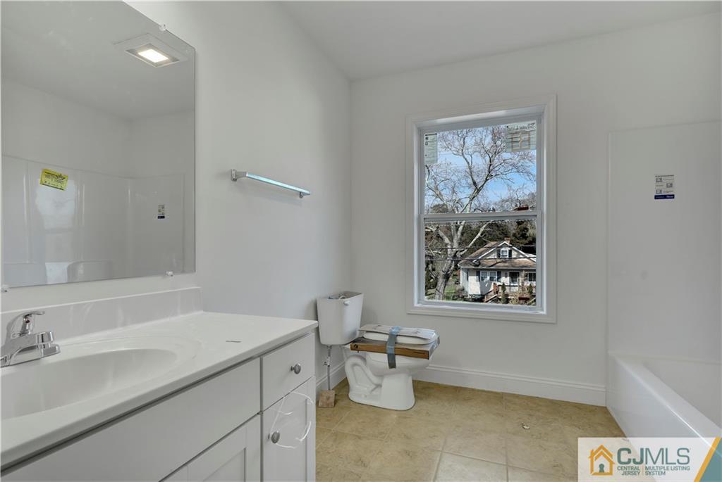 11 Addison Road Howell, NJ 07731 - Photo 16 of 25 a bathroom with a granite countertop toilet a sink and a mirror