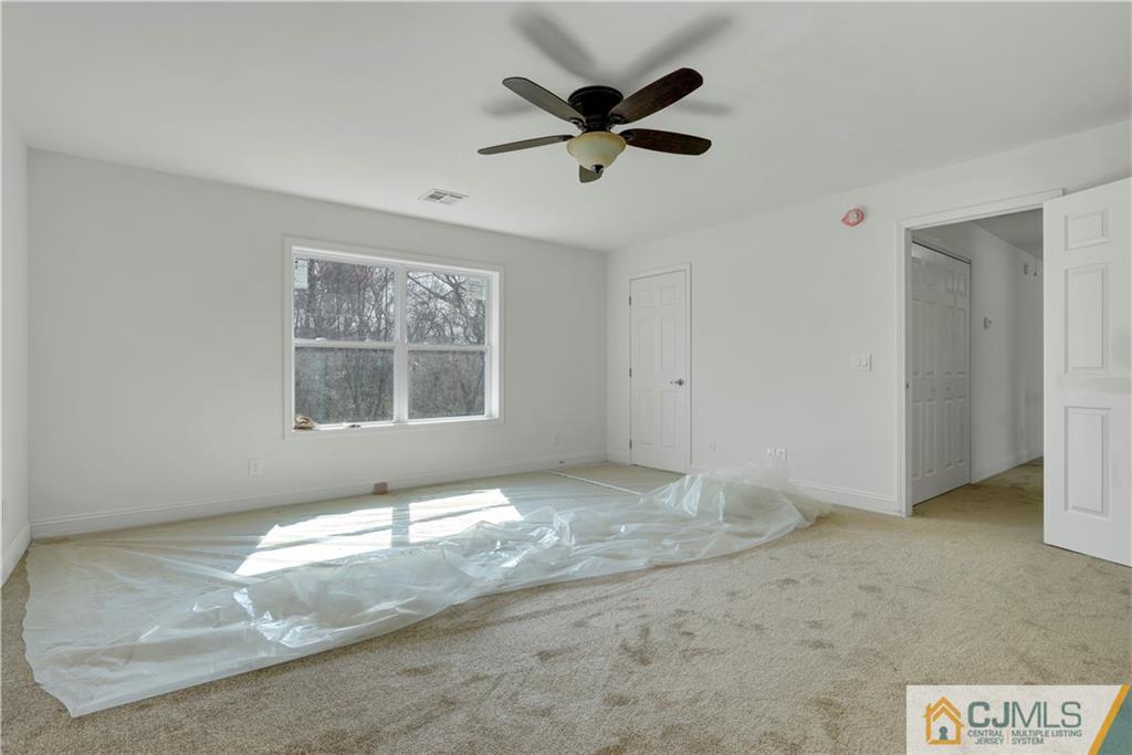 11 Addison Road Howell, NJ 07731 - Photo 17 of 25 an empty room with a window and a ceiling fan