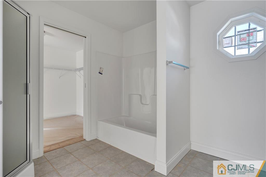 11 Addison Road Howell, NJ 07731 - Photo 18 of 25 a bathroom with a bathtub and shower