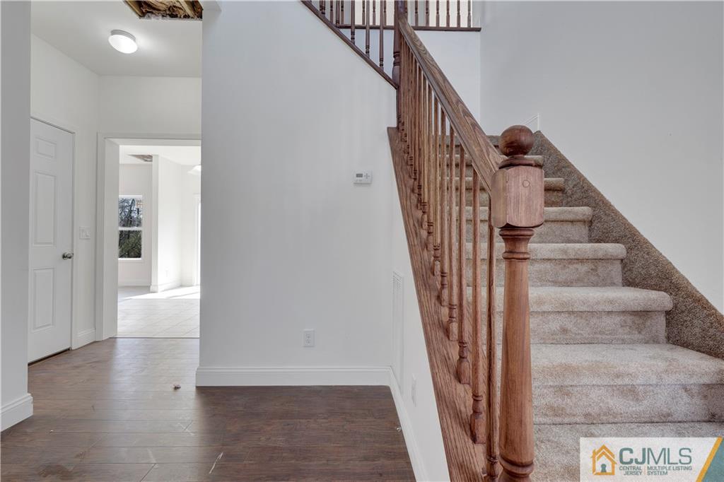 11 Addison Road Howell, NJ 07731 - Photo 3 of 25 a view of entryway and hall with wooden floor