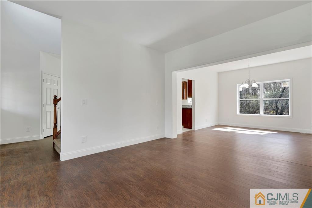 11 Addison Road Howell, NJ 07731 - Photo 5 of 25 an empty room with wooden floor and windows