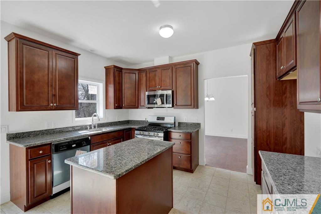 11 Addison Road Howell, NJ 07731 - Photo 9 of 25 a kitchen with stainless steel appliances granite countertop a stove a sink and a microwave