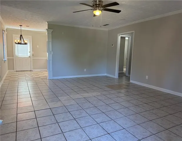 a view of a livingroom with an empty space and a chandelier fan