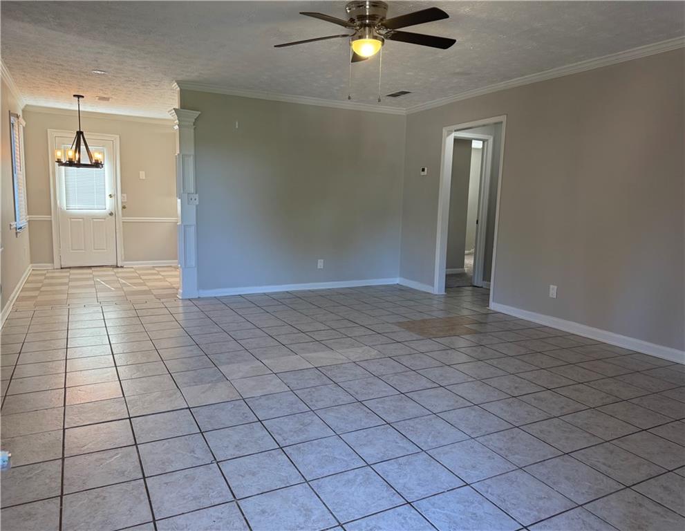 452 Lexington Drive Lawrenceville, GA 30046 - Photo 2 of 9 a view of a livingroom with an empty space and a chandelier fan
