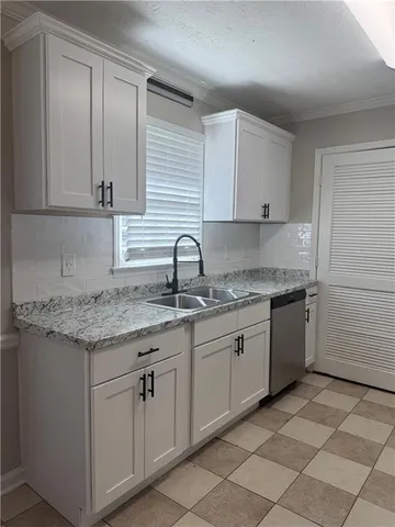 a kitchen that has a sink and cabinets