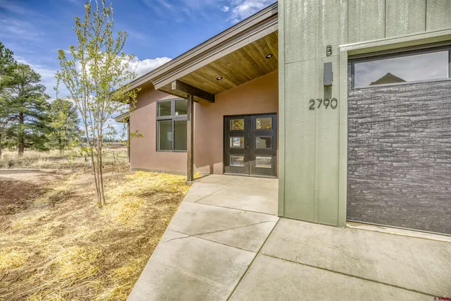 a large white kitchen with a large window