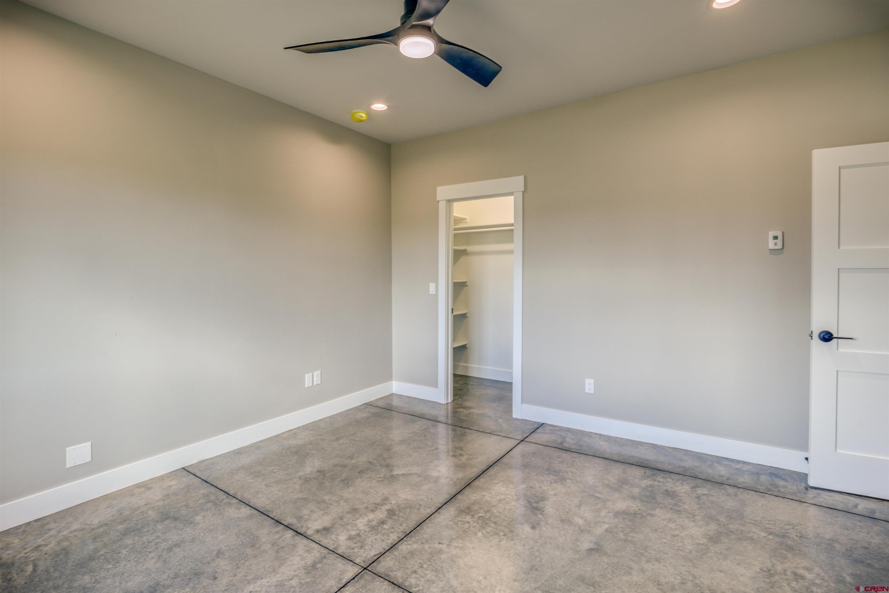 2790 Rock Road, Unit B Pagosa Springs, CO 81147 - Photo 17 of 43 an empty room with a ceiling fan and carpet