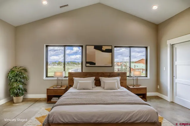 a bedroom with a large bed and a flat screen television