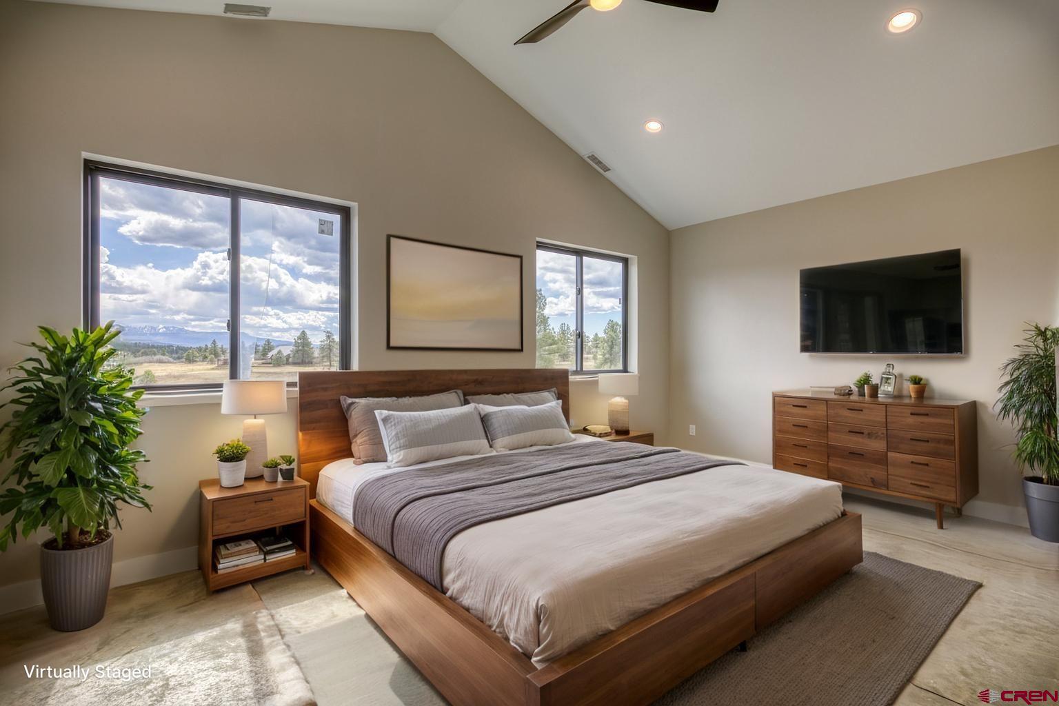 2790 Rock Road, Unit B Pagosa Springs, CO 81147 - Photo 34 of 43 a bedroom with a large bed and a flat screen television