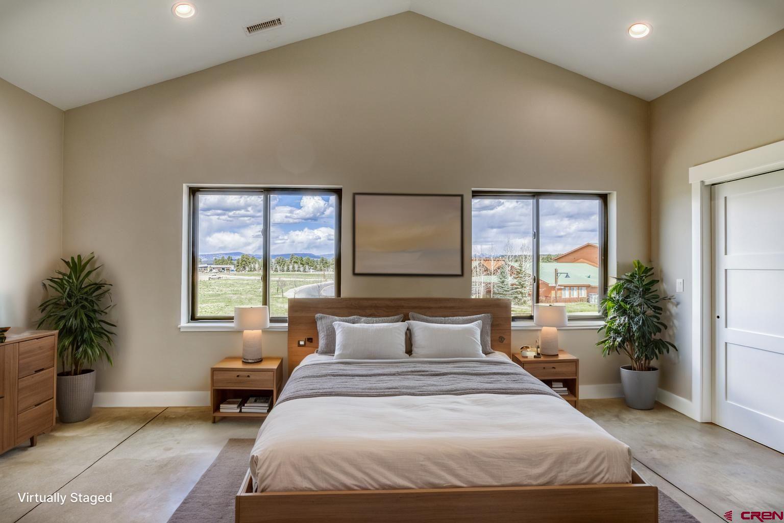 2790 Rock Road, Unit B Pagosa Springs, CO 81147 - Photo 35 of 43 a bedroom with a large bed and a potted plant