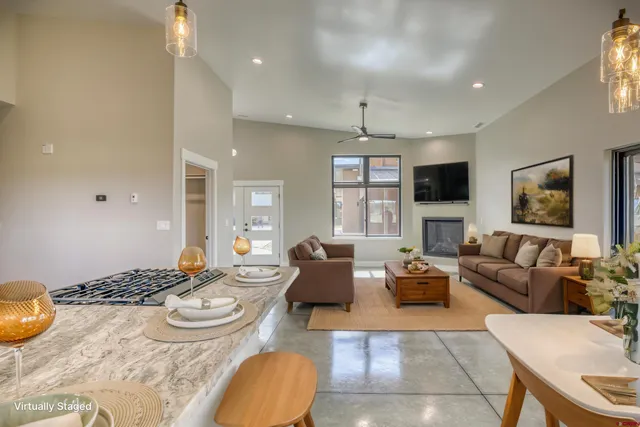 a living room with furniture and a chandelier