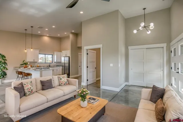 a living room with furniture and a chandelier