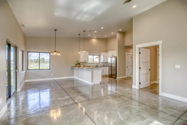 a view of kitchen with granite countertop cabinets and window