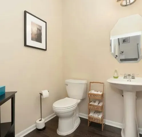a white toilet sitting next to a bathroom sink