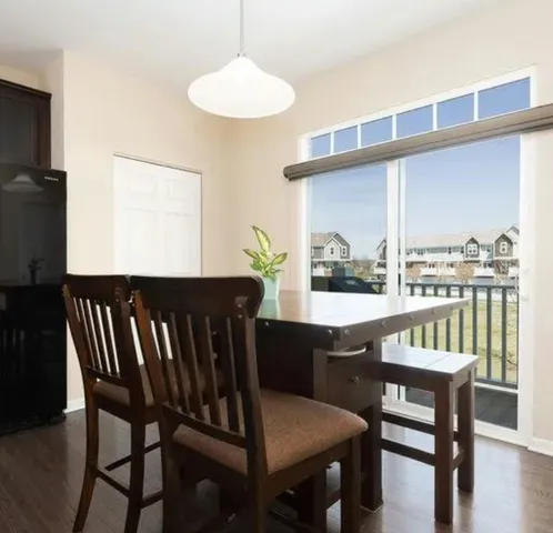 a kitchen with a dining table chairs and chandelier