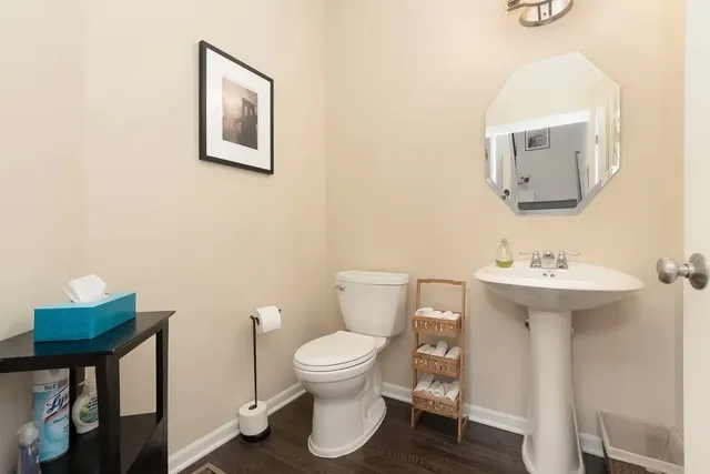 a bathroom with a toilet sink and mirror
