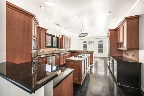 a kitchen with stainless steel appliances granite countertop a stove a sink dishwasher and cabinets