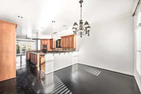 a view of kitchen and hall with wooden floor