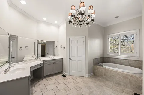 a spacious bathroom with a sink mirror and a bathtub