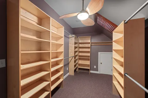 a view of an empty room with wooden stairs