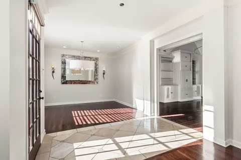 a living room with a bed and a painting on the wall