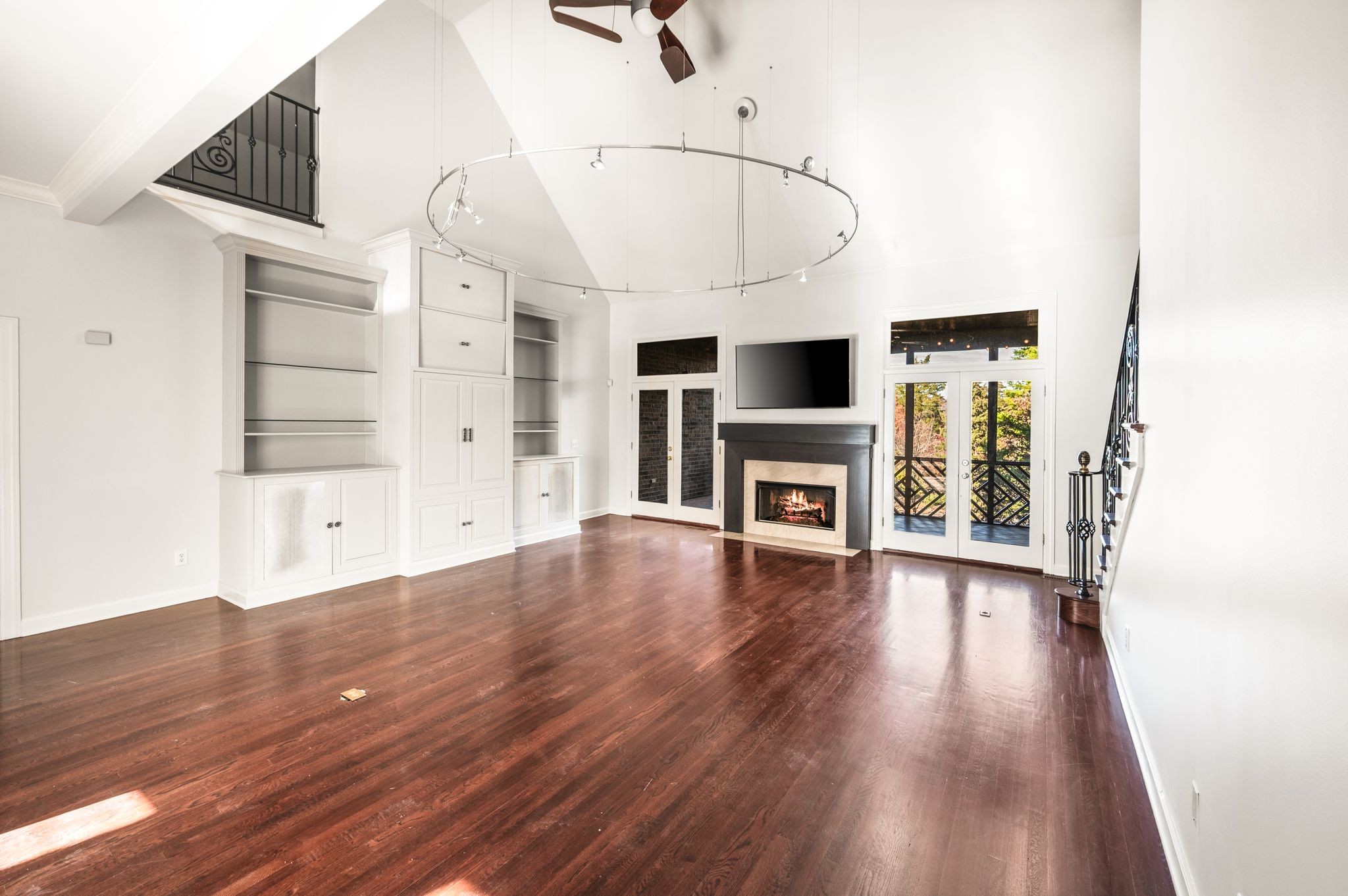 1060 Stonebridge Park Drive Franklin, TN 37069 - Photo 7 of 51 an empty room with wooden floor fireplace and windows