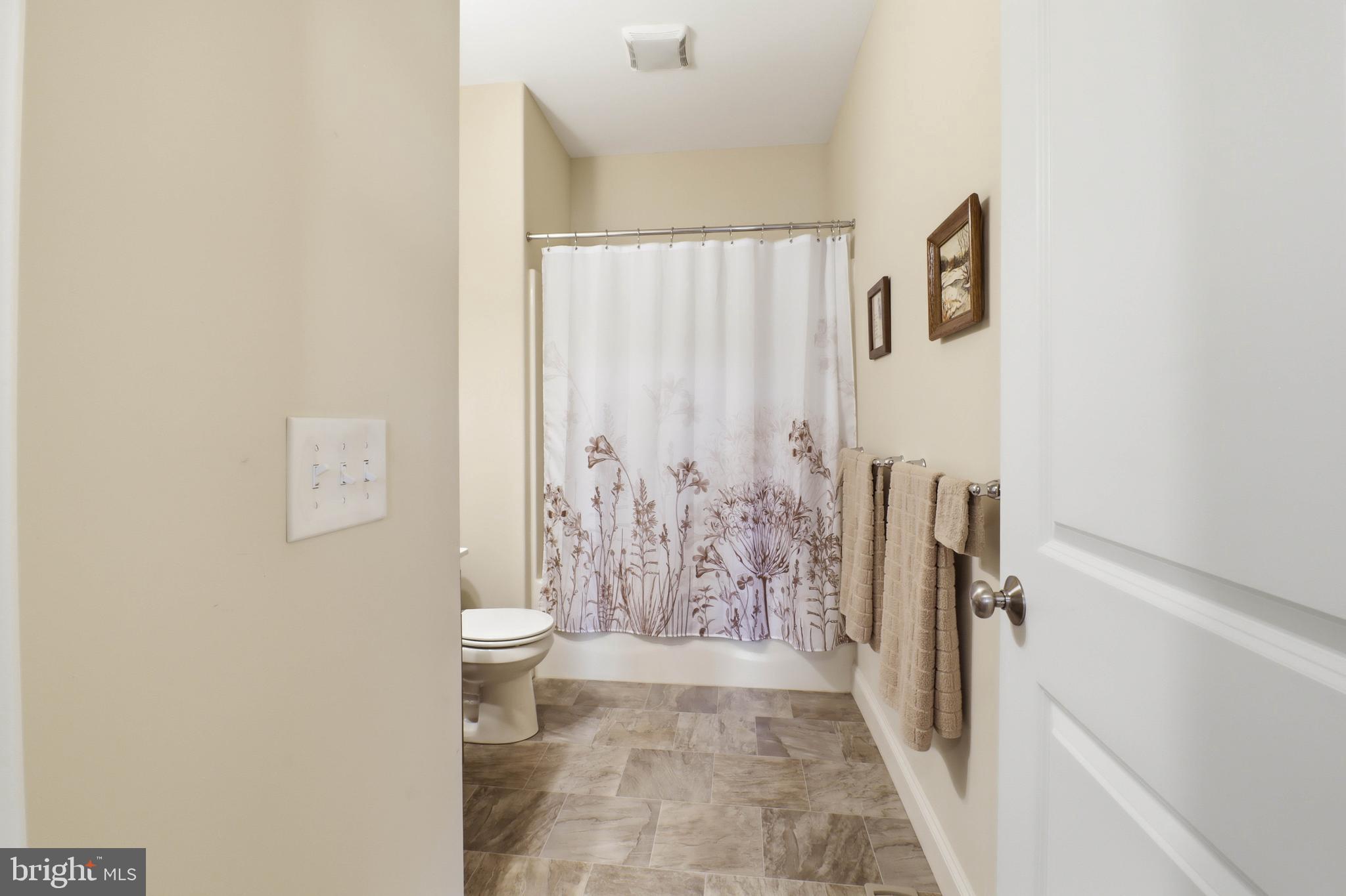 637 Lititz Reserve Lane Lititz, PA 17543 - Photo 16 of 31 a bathroom with a shower curtain and a toilet