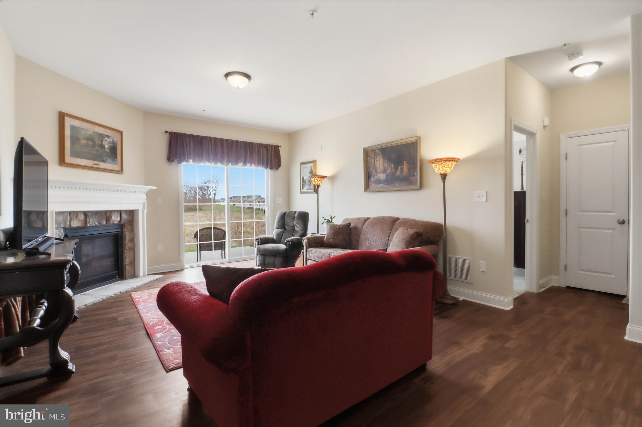 637 Lititz Reserve Lane Lititz, PA 17543 - Photo 5 of 31 a living room with furniture a fireplace and a flat screen tv