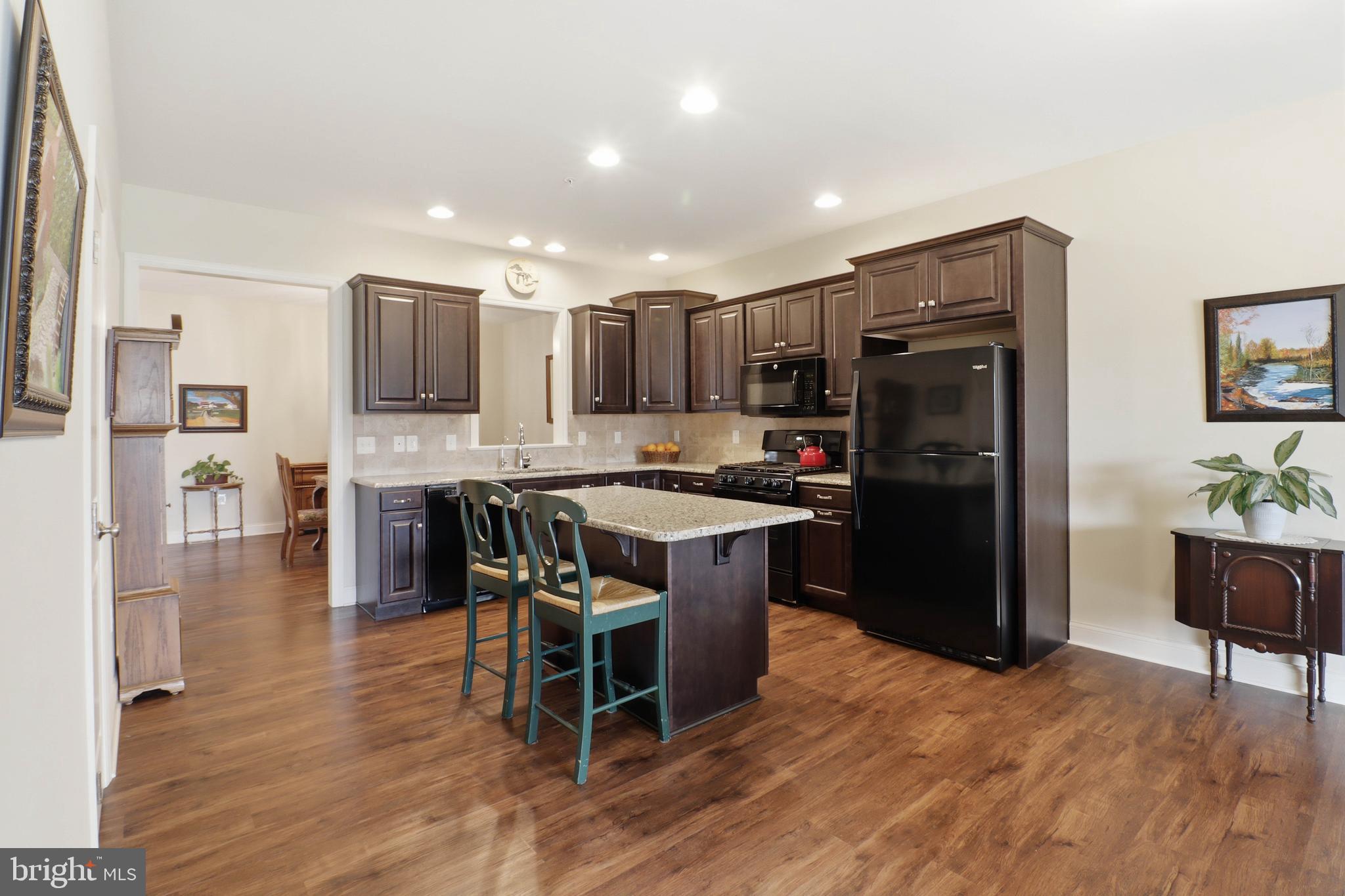 637 Lititz Reserve Lane Lititz, PA 17543 - Photo 6 of 31 a kitchen with stainless steel appliances kitchen island granite countertop a refrigerator and a stove top oven