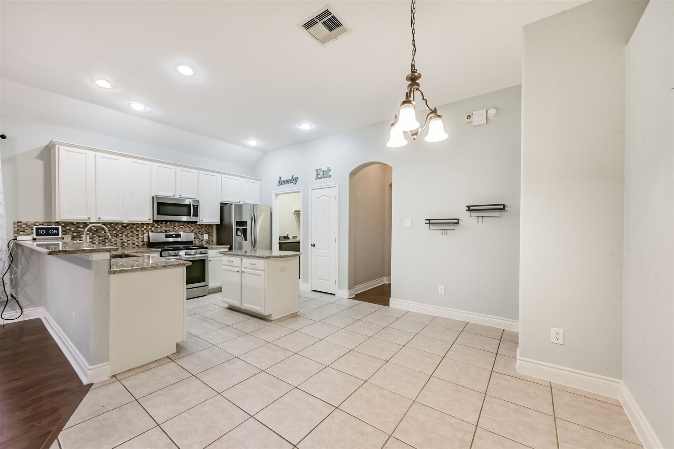 1065 Brigid Court Dickinson, TX 77539 - Photo 14 of 37 a kitchen with white cabinets and refrigerator