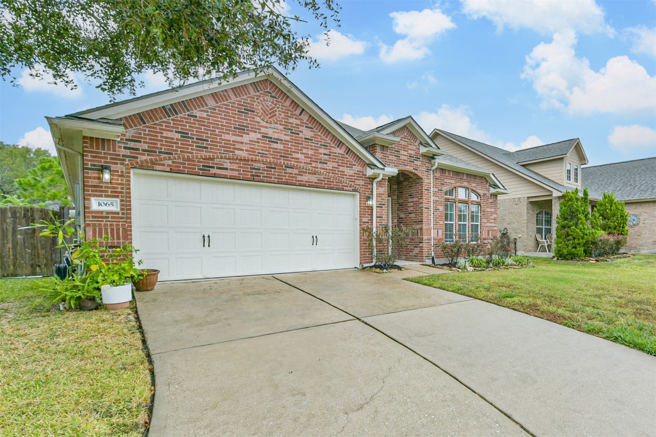 1065 Brigid Court Dickinson, TX 77539 - Photo 2 of 37 a front view of a house with a garden and plants