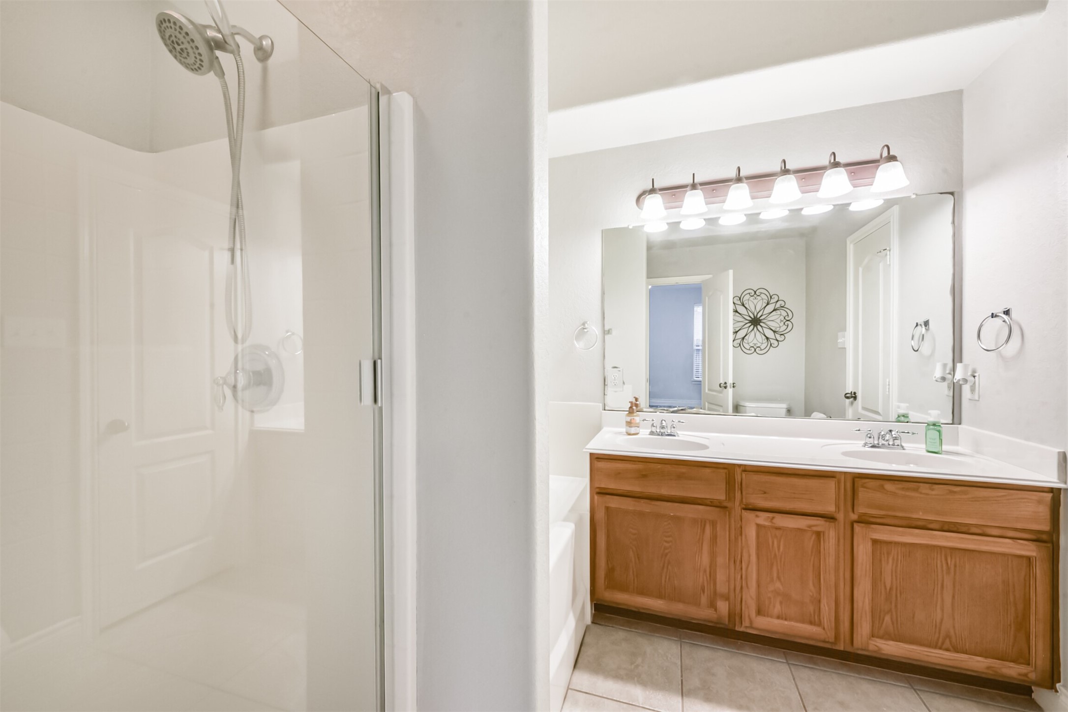 1065 Brigid Court Dickinson, TX 77539 - Photo 21 of 37 a bathroom with a double vanity sink and a mirror